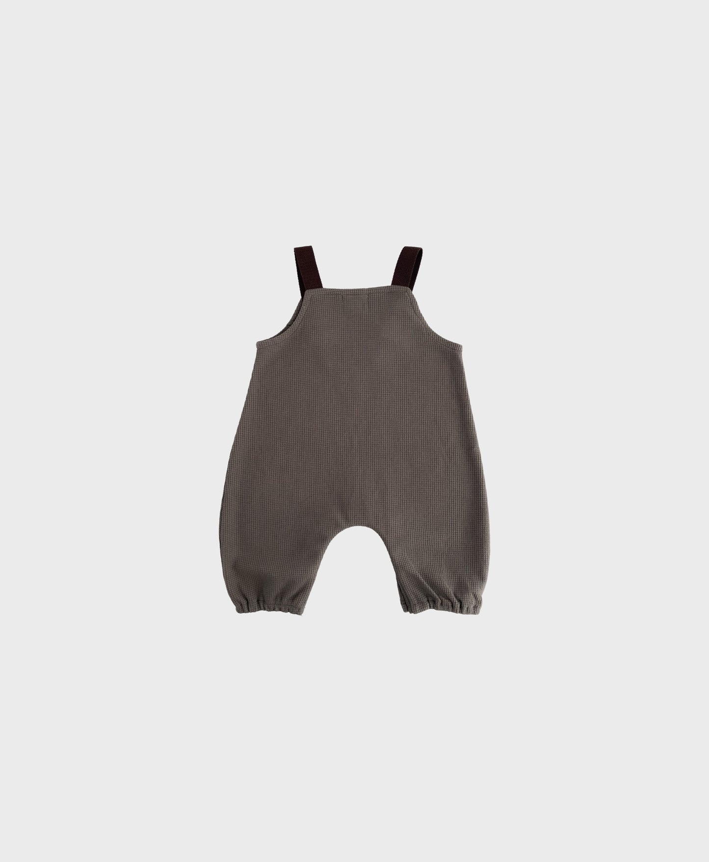 Stylish hip baby boy clothing: Brown sleeveless overall with brown straps.