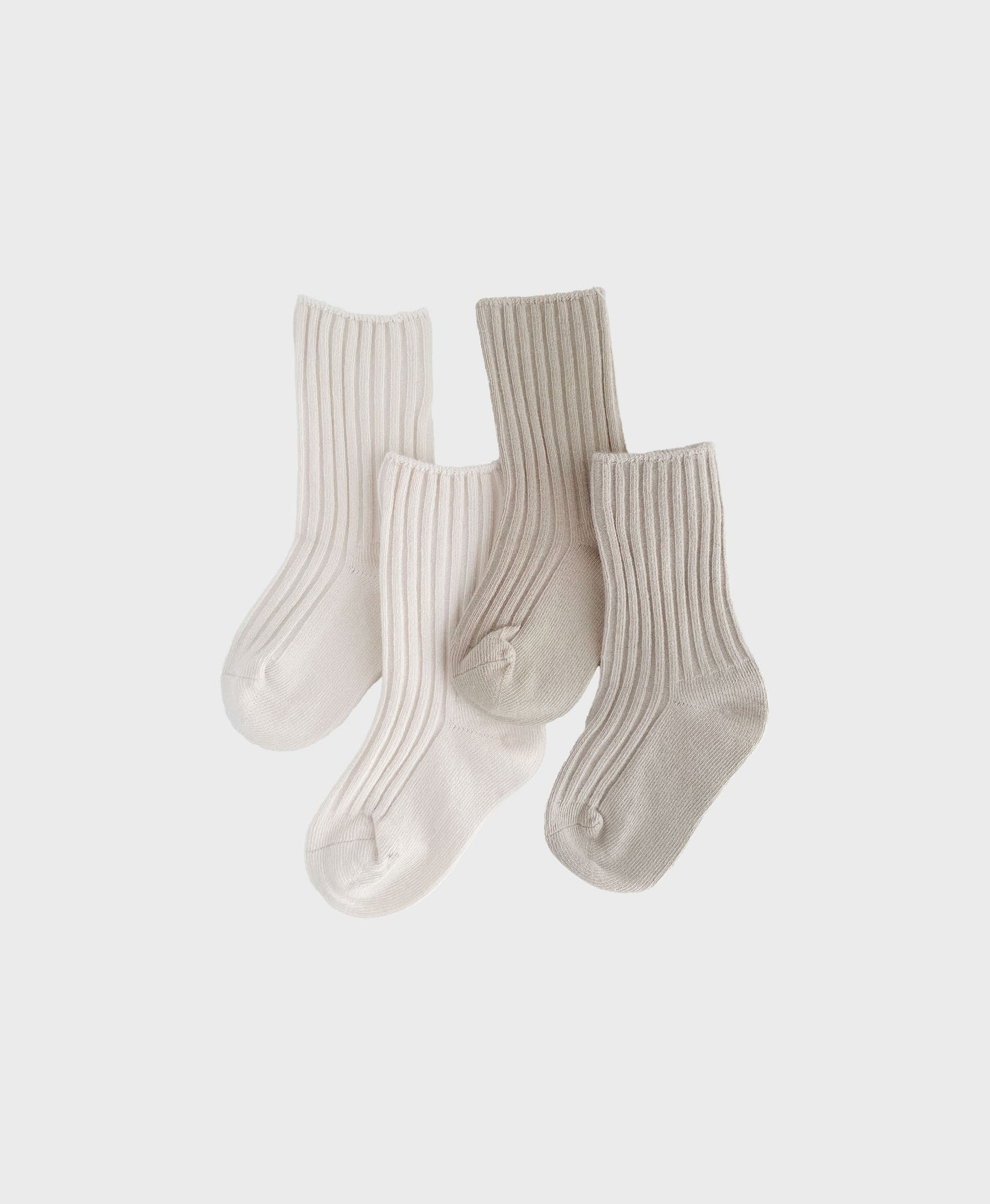 Two pairs of baby socks in white and beige. Affordable Luxury - Combed Cotton baby Socks - Matching baby and toddler outfits.