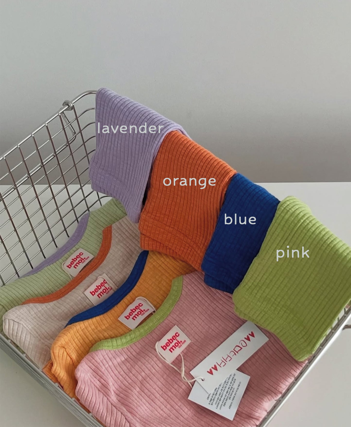 Unique baby clothes set with a mix of earthy and pastel tops and pants, made from soft, elastic fabric