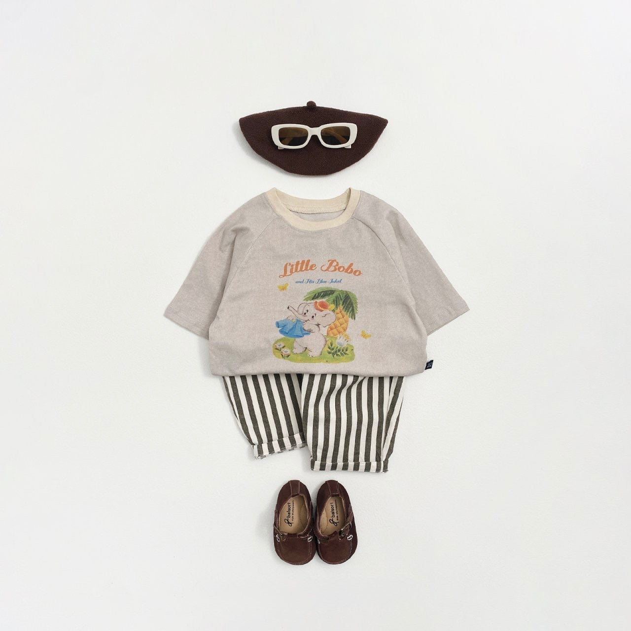 Children's outfit with gray vintage shirt, striped pants, hat, and shoes