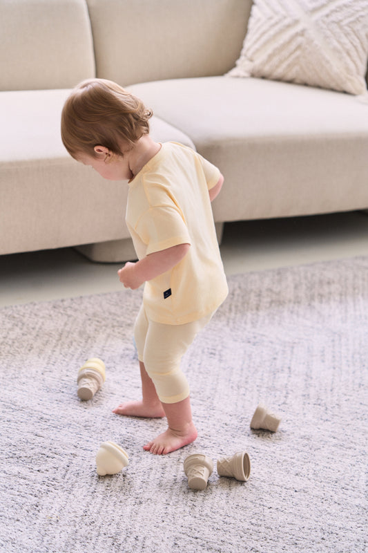 Cute toddler boy clothes styled playing in the room