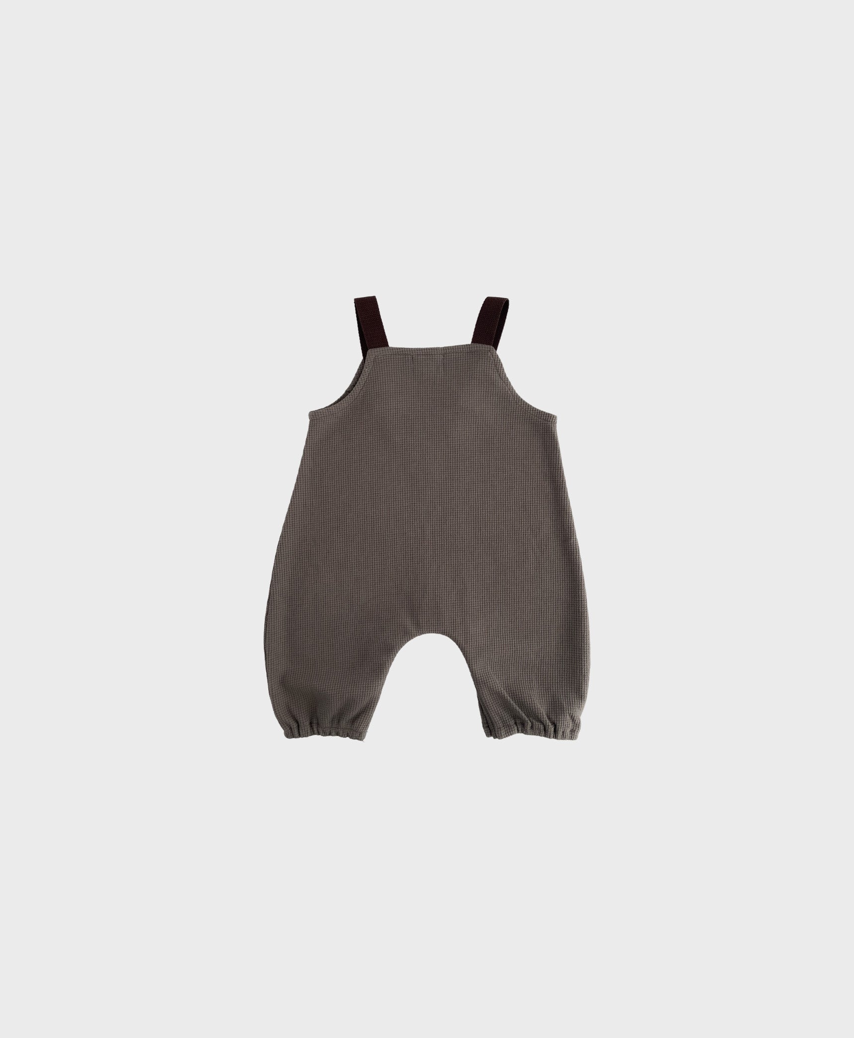 Stylish hip baby boy clothing: Brown sleeveless overall with brown straps.
