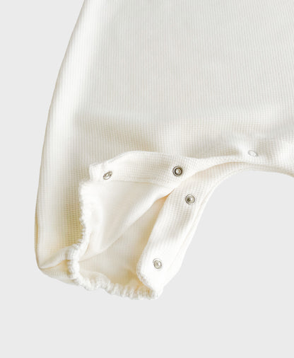 Hipster baby boy clothes: details of Ivory sleeveless overall with easy snap buttons.