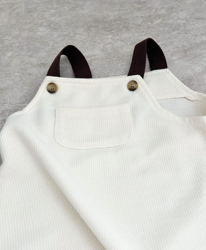 Brown strap sleeveless overall for hip baby boy with snap buttons in clutch..