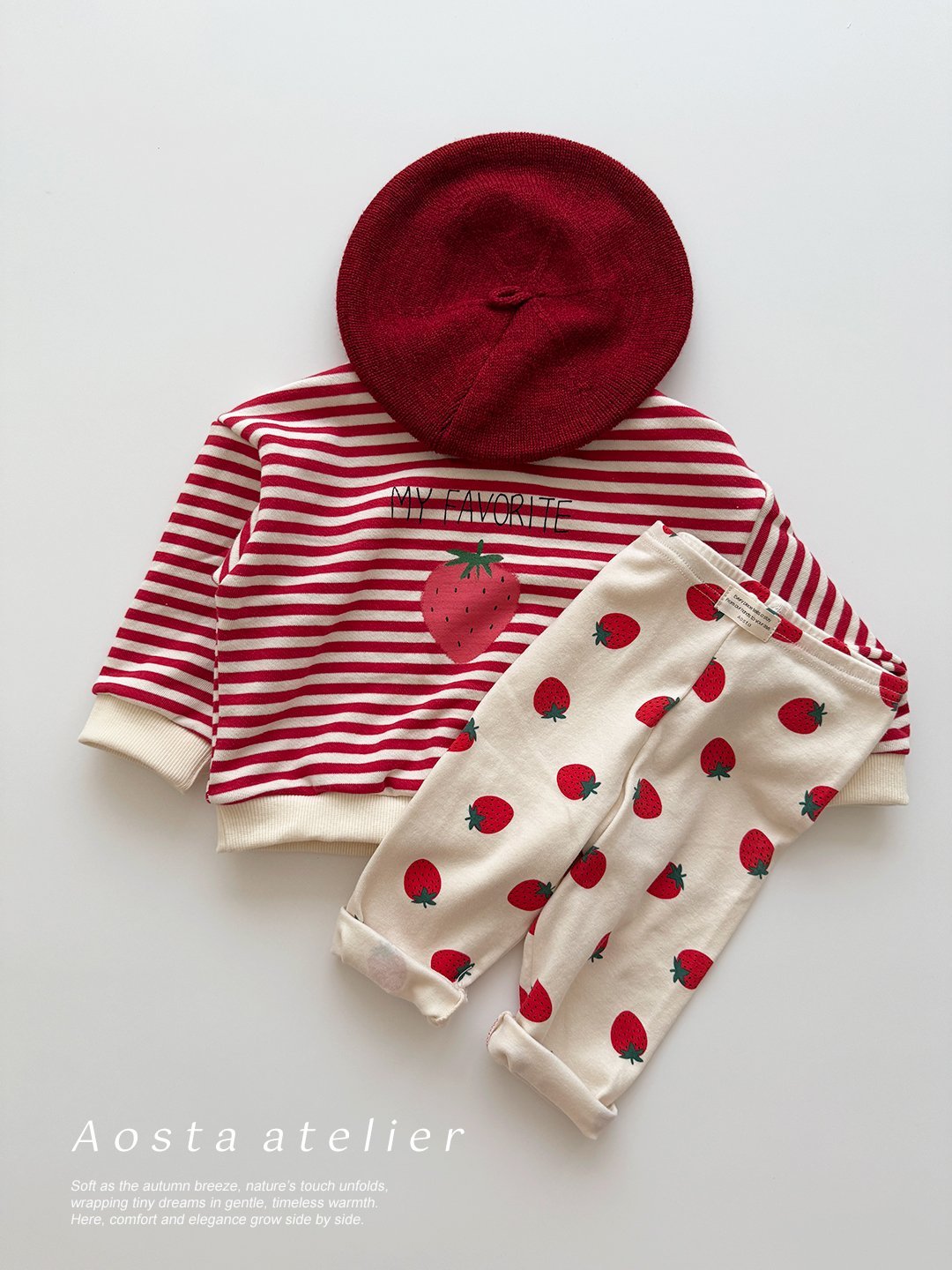 baby toddler's outfit with red and white striped shirt, red beret, and strawberry-patterned design