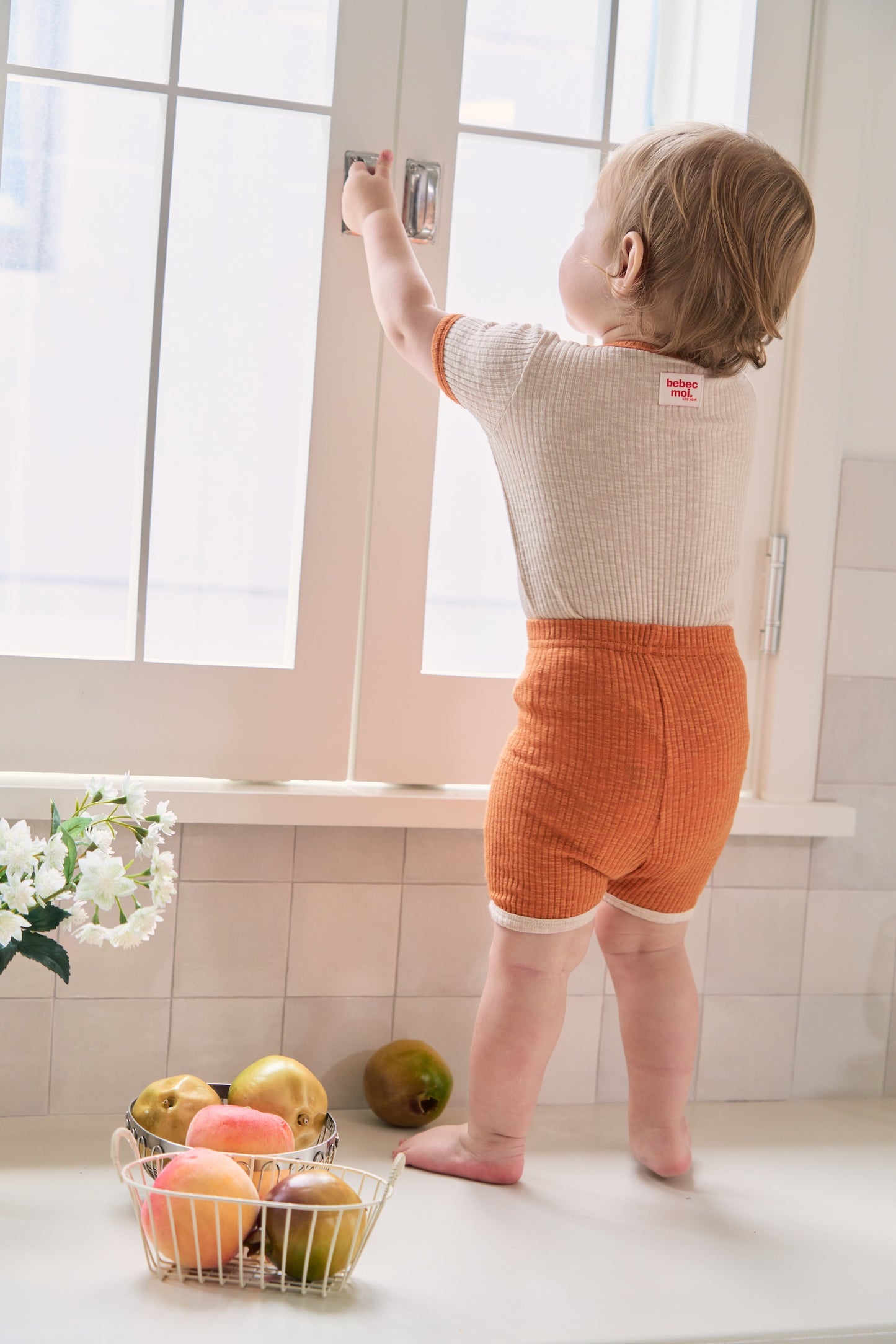 Unique baby clothes in gender-neutral tones with comfy stretch materials