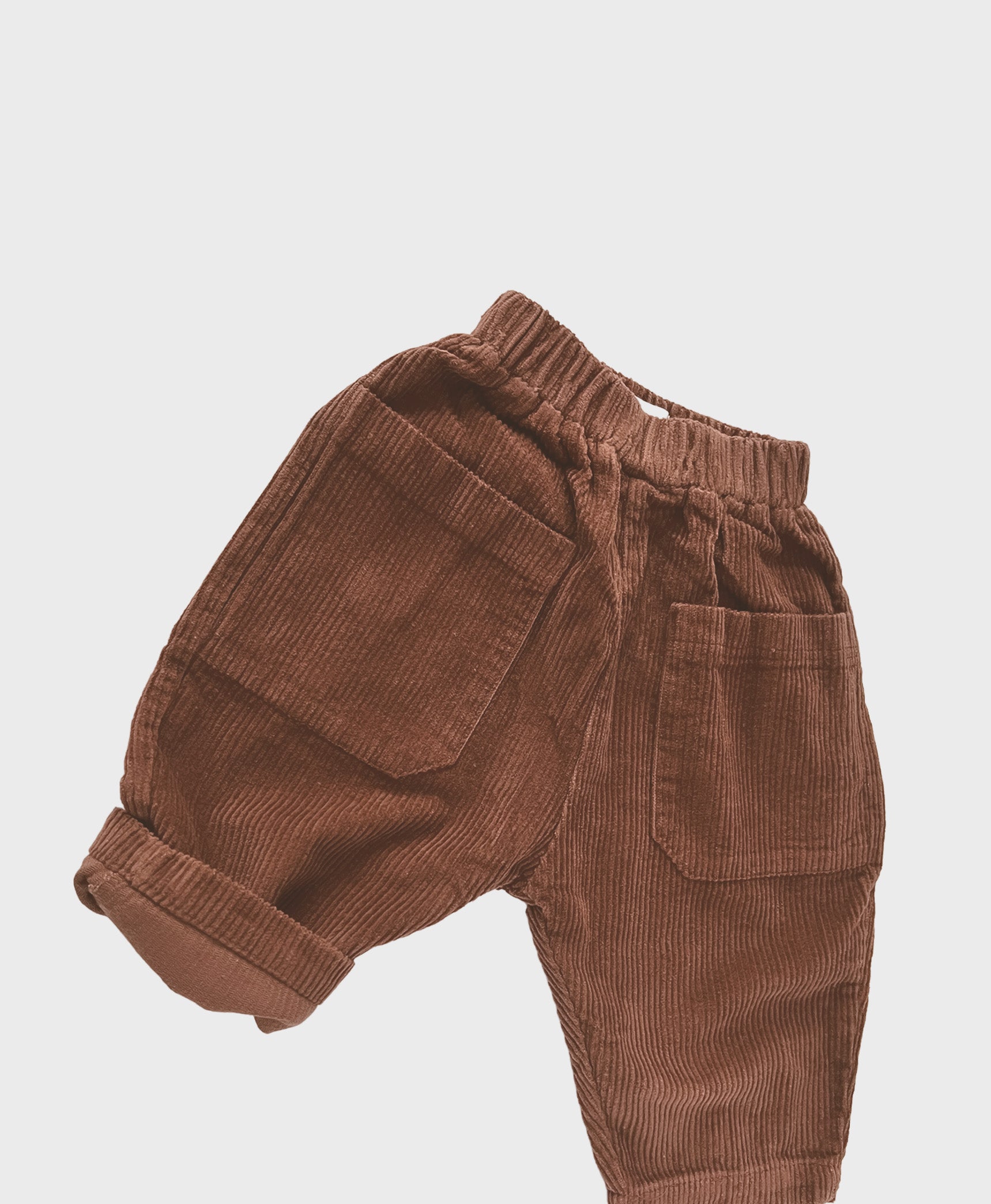Brown baby corduroy pants with large front pockets, designed for baby boy dedication clothes, and hip baby boy clothing