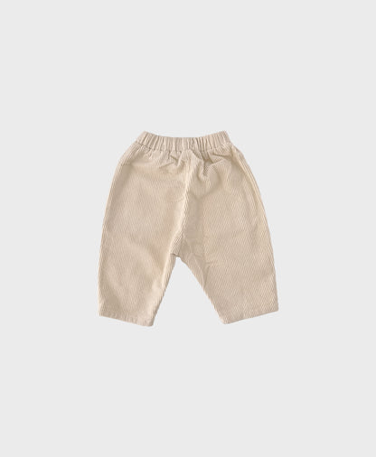 Creme baby corduroy pants with large front pockets, designed for comfort and trendy baby clothes boy