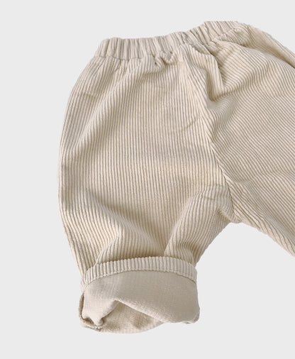 Creme baby corduroy pants with large front pockets, designed for baby boy dedication clothes, and hip baby boy clothing