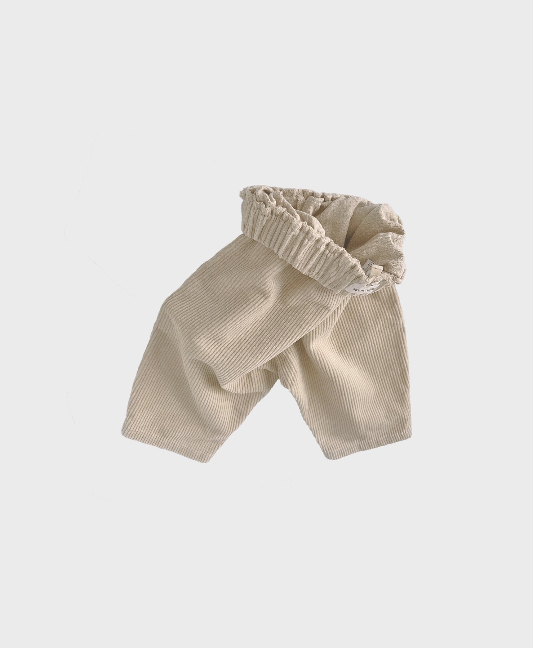 Creme baby corduroy pants with large front pockets, designed for trendy baby clothes boy and hip baby boy clothing
