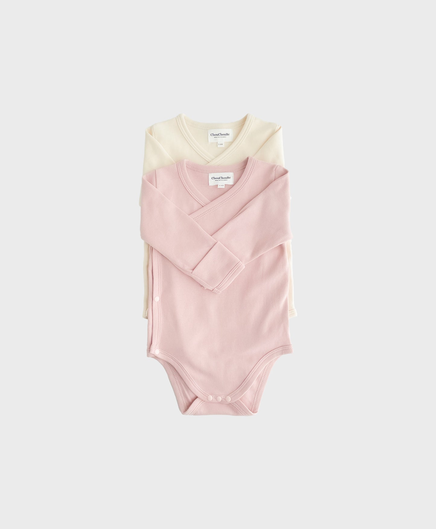 newborn outfit set with hat, including kimono-style bodysuit with snap buttons.