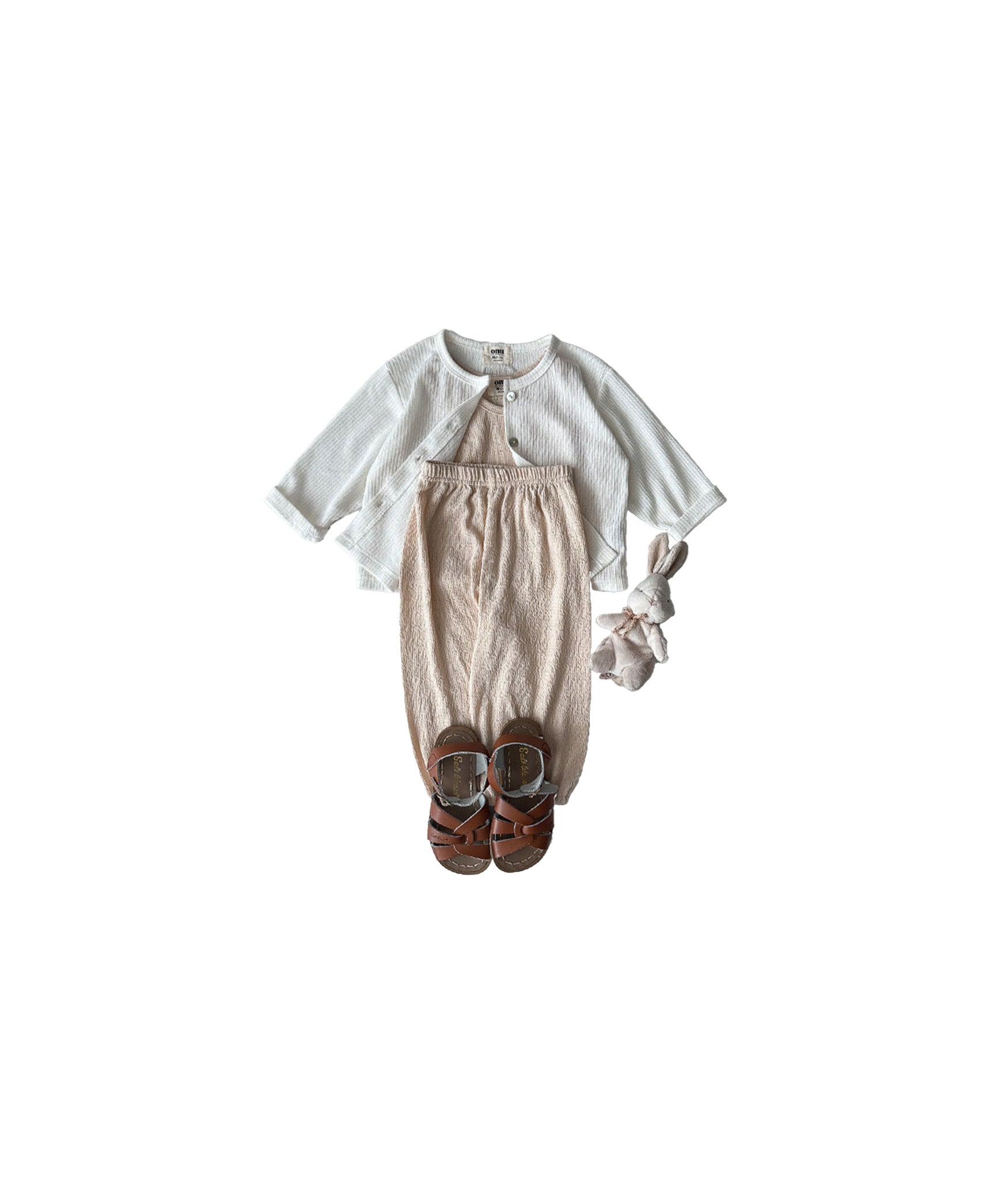 Cardigan outfit in soft tones, representing cool baby boy clothes with a fashionable edge
