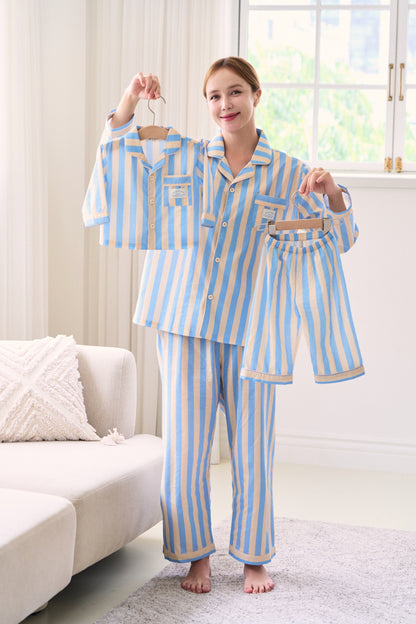 Mom in pajamas that match her baby’s outfit from a mommy and me pajamas set