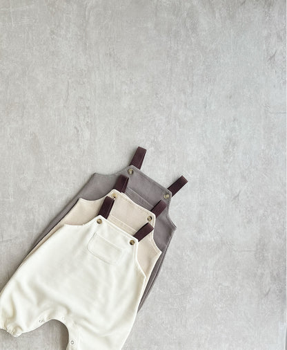 A collection of sleeveless overall with brown straps for hip baby boy with snap buttons.