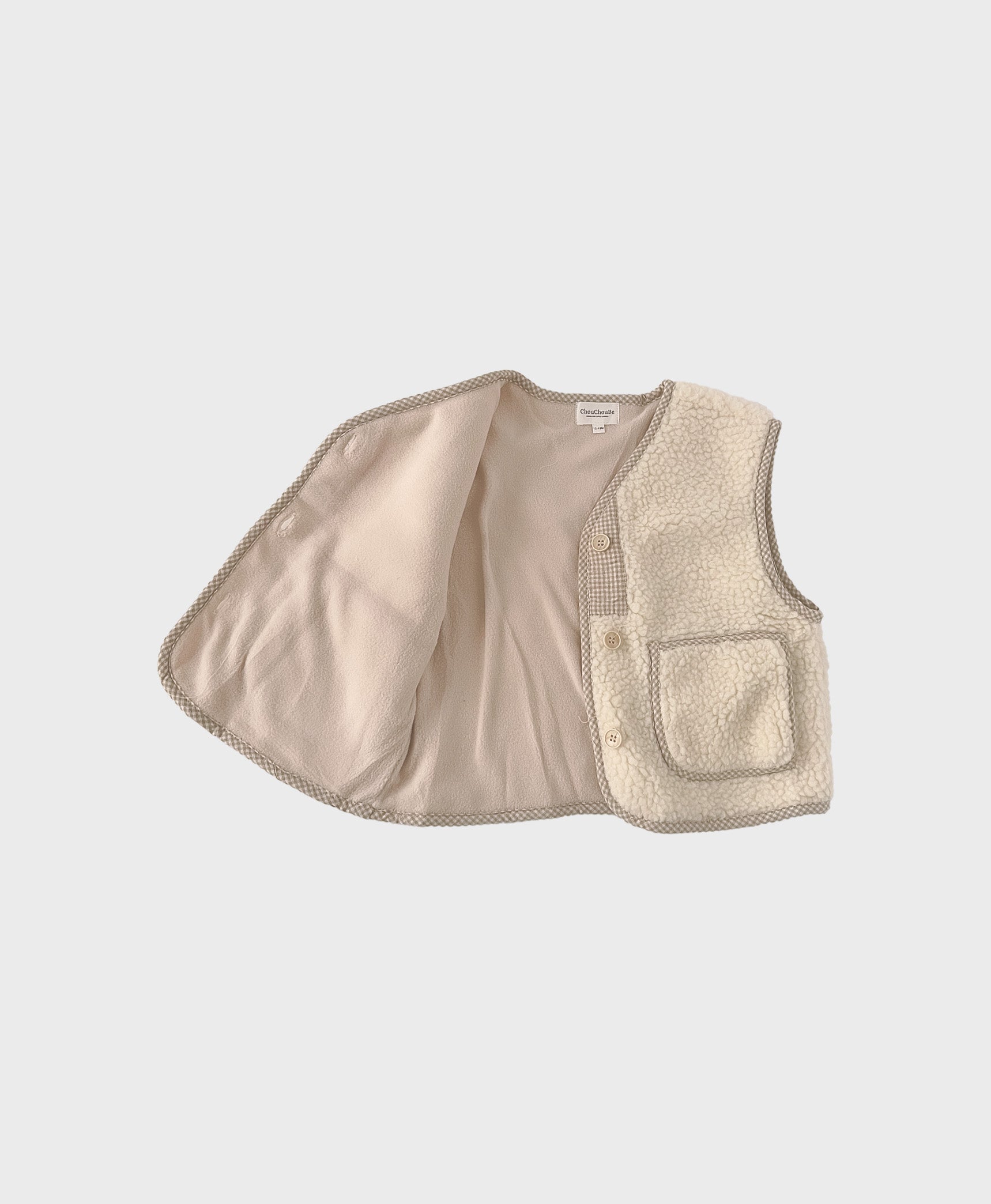 Beige cozy baby vest made of soft fleece, showcasing front pockets, perfect for baby boy boutique clothing